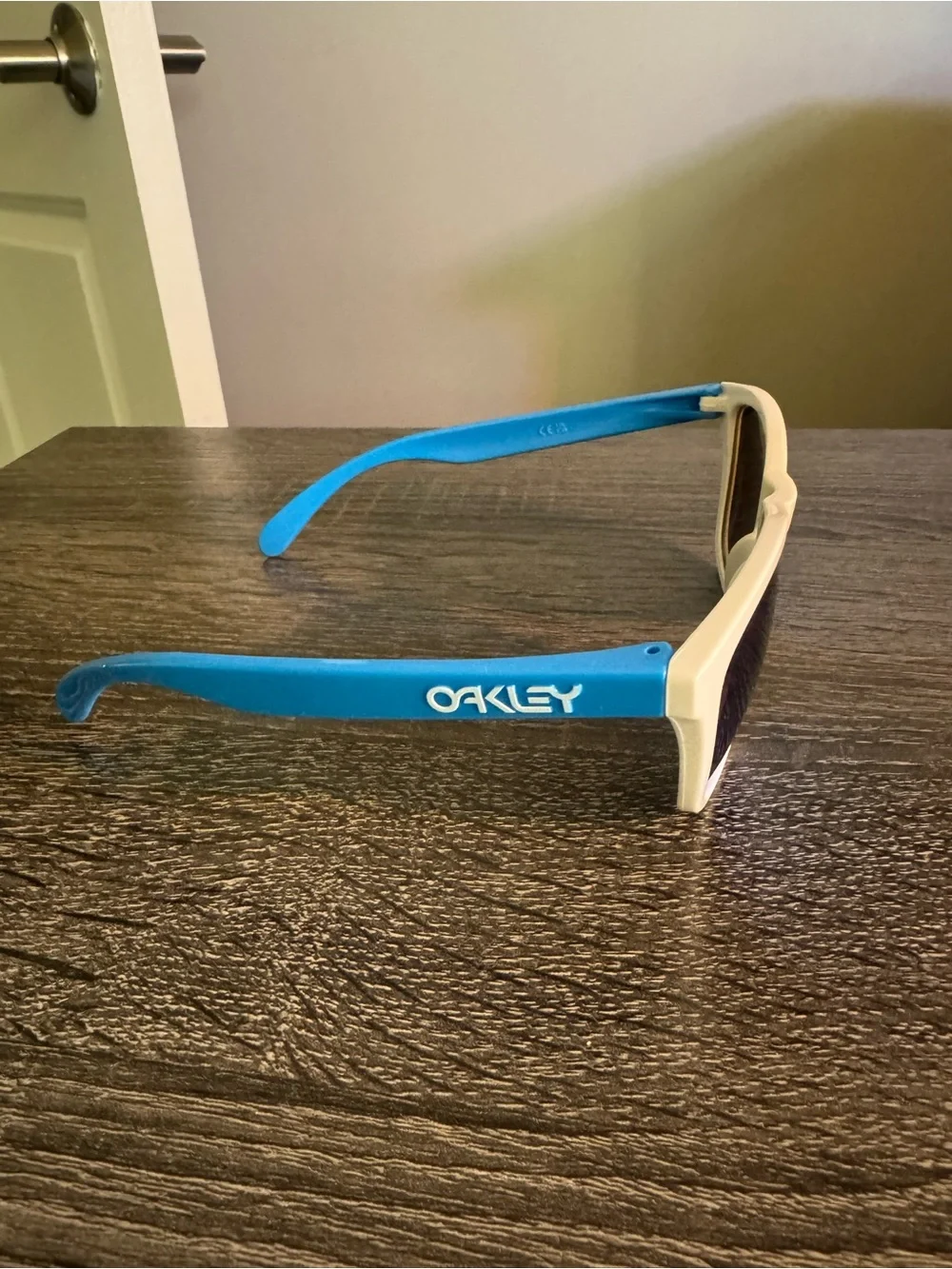 Oakley White Frame Sunglasses with Blue Mirrored Lenses